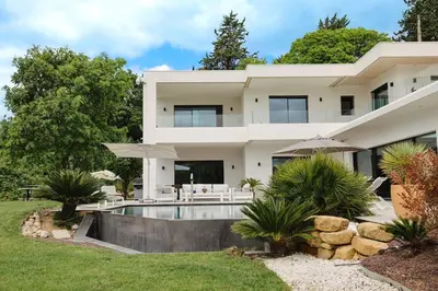 a large white house with a swimming pool at Villa contemporaine de luxe in Aix-en-Provence