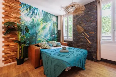 a room with a table and a large mural at Bali Dream I Hyper Centre Fountain Moussue in Salon-de-Provence