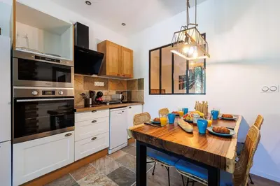 a kitchen with a wooden table with food on it at Bali Dream I Hyper Centre Fountain Moussue in Salon-de-Provence