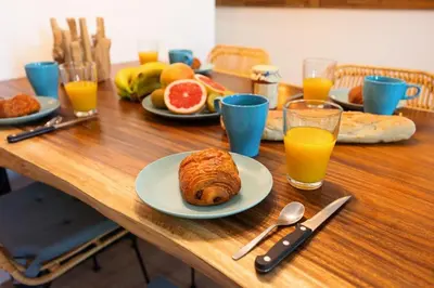 a table with plates of food and glasses of orange juice at Bali Dream I Hyper Centre Fountain Moussue in Salon-de-Provence