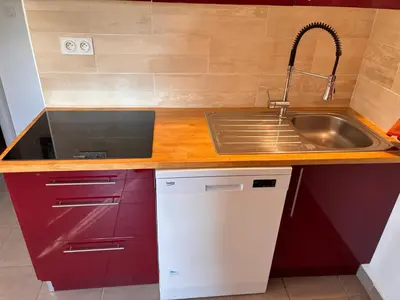 a kitchen with a sink and a stainless steel sink at Au doux paillis soleil couchant in Le Thor