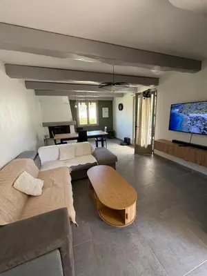 a living room with a couch and a table at La Tobynette in LʼIsle-sur-la-Sorgue