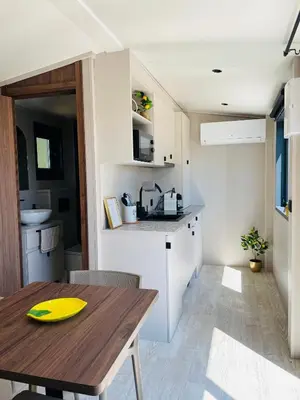 a kitchen with a wooden table and a dining room at Tiny Aix - Maison Odonata in Aix-en-Provence