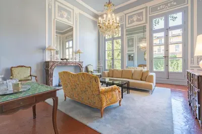 a living room with a couch and a chandelier at Cardinale 4 rooms in Aix-en-Provence