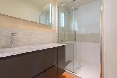 a bathroom with a glass shower and a sink at Cardinale 4 rooms in Aix-en-Provence