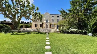 a stone path in the yard of a mansion at Château vert in Cavaillon