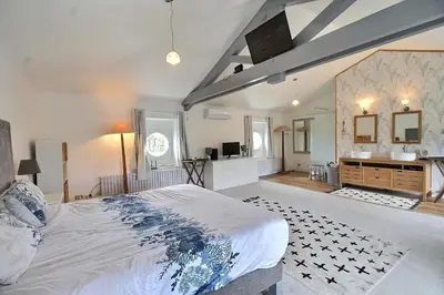 a large bedroom with a large bed and a bathroom at Château vert in Cavaillon