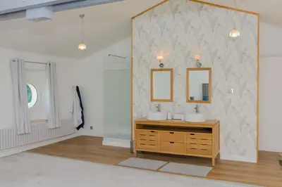 a bathroom with two sinks and a mirror at Château vert in Cavaillon