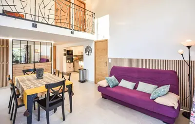 a living room with a purple couch and a table at Tranquil Cottage With Views Of Mont Ventoux in Les Gaps