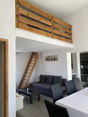 a living room with a couch and a loft at Un jour en Provence in Cabannes