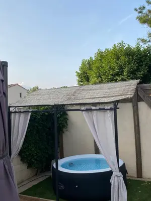a gazebo with a pool in a backyard at Un jour en Provence in Cabannes