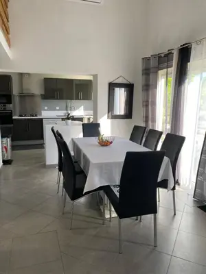 a kitchen and dining room with a table and chairs at Un jour en Provence in Cabannes