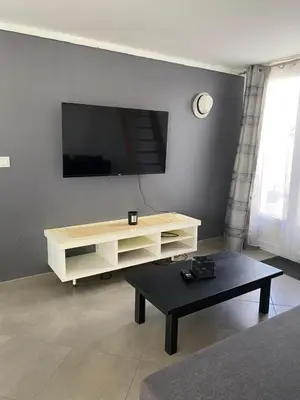 a living room with a tv and a coffee table at Un jour en Provence in Cabannes