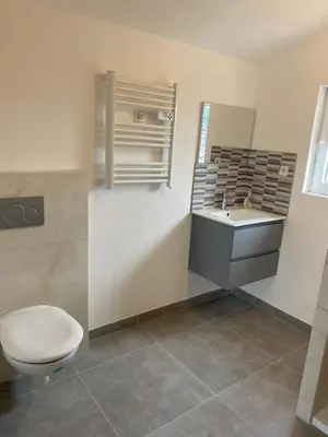 a bathroom with a toilet and a sink and a mirror at Un jour en Provence in Cabannes