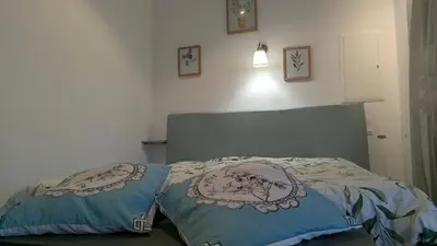 a bedroom with a bed with two pillows on it at Gite Le Petit Luberon LISIANTHUS in Cabrières-dʼAvignon