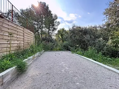 a dirt road with a fence on the side at Chambre Deluxe - vue jardin - située dans le triangle d'or du Luberon in Ménerbes