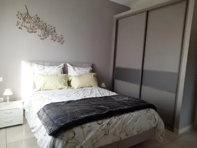 a bedroom with a bed with a black blanket on it at Maison en Provence in Jouques