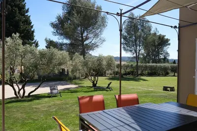 a table and chairs in a yard with trees at Villa overlooking the Alpilles Saint Remy de Provence LS1-454 in Saint-Rémy-de-Provence