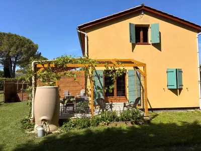 a house with a gazebo in the yard at Au doux paillis Sorgue in Le Thor