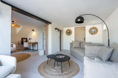 a living room with a couch and a table at La Note Bleue Luberon in Maubec