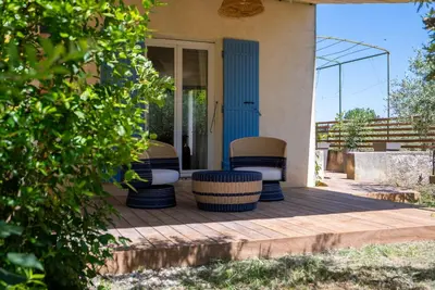 a porch of a house with chairs on it at La Note Bleue Luberon in Maubec