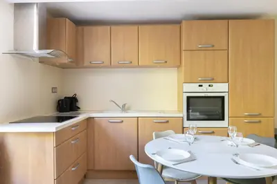 a kitchen with a white table and chairs in it at Le Lavandin - 3 to 4 beds - Hypercentre - Wifi in Apt