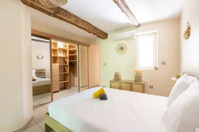 a bedroom with a white bed and a mirror at Le Lavandin - 3 to 4 beds - Hypercentre - Wifi in Apt