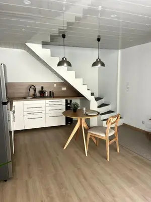 a kitchen and dining room with a table and stairs at jungle room in La Tour-dʼAigues