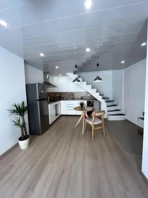 a kitchen with a staircase and a table and chairs at jungle room in La Tour-dʼAigues
