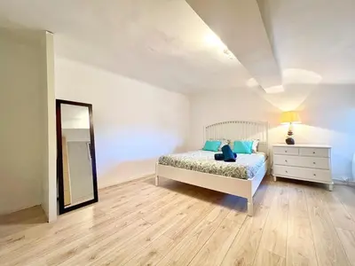 a bedroom with a bed and a dresser and a mirror at Miraluna - Village médiéval, calme, insolite, 6 personnes in Miramas