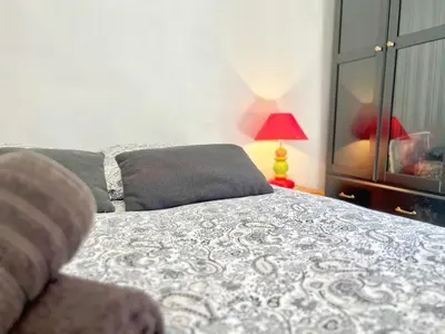 a bedroom with a bed and a lamp and a window at Miraluna - Village médiéval, calme, insolite, 6 personnes in Miramas