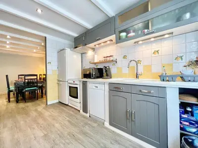 a kitchen with stainless steel appliances and a table at Miraluna - Village médiéval, calme, insolite, 6 personnes in Miramas