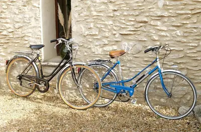 two bikes are parked next to a building at La Grande Bergerie in Saint-Saturnin-les-Apt