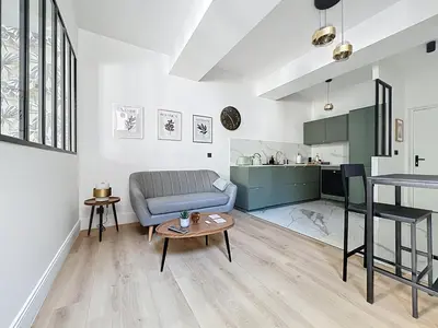 a living room with a couch and a table at Côté Palmier - Luxurious 2-room - Center-by PauseAixoise in Aix-en-Provence