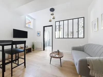 a living room with a couch and a table at Côté Palmier - Luxurious 2-room - Center-by PauseAixoise in Aix-en-Provence