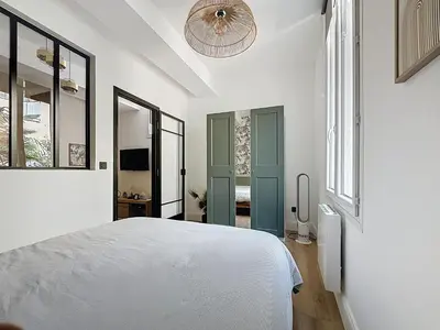 a bedroom with a white bed and a ceiling fan at Côté Palmier - Luxurious 2-room - Center-by PauseAixoise in Aix-en-Provence