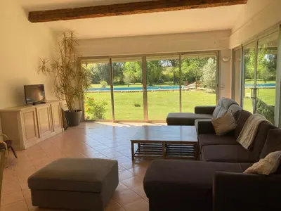 a living room with a couch and a table at Grande maison avec piscine in Aix-en-Provence