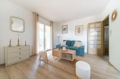 a living room with a blue couch and a table at Maison proche Avignon Clim Terrasse wifi 4pers in Jonquerettes