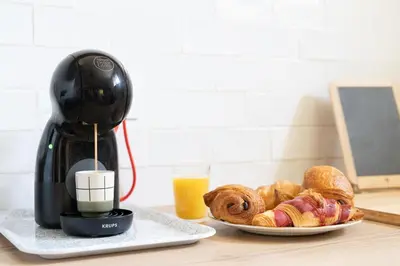 a coffee maker and a plate of pastries on a table at Maison proche Avignon Clim Terrasse wifi 4pers in Jonquerettes