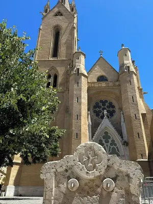 a large church with a clock tower on top of it at La Suite 4 Dauphins- Aix en Provence in Aix-en-Provence