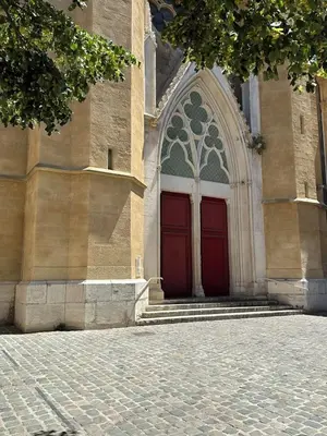 a church with a red door and stairs in front at La Suite 4 Dauphins- Aix en Provence in Aix-en-Provence