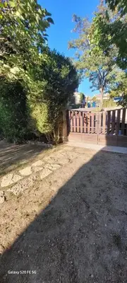 a wooden fence in front of a house at Maison conviviale avec jardin à Revest-des-Brousses in Vachères