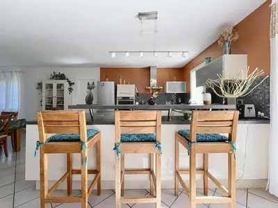 a kitchen with two wooden stools at a counter at Casa du Luberon in Maubec