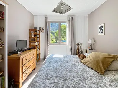 a bedroom with a dog laying on a bed at Casa du Luberon in Maubec