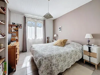 a bedroom with a large bed and a window at Casa du Luberon in Maubec