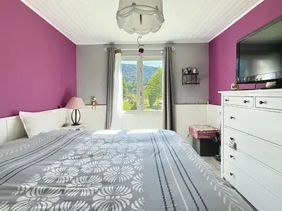a bedroom with purple walls and a large bed at Casa du Luberon in Maubec