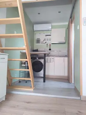 a kitchen with a desk in the middle of a room at Mayka in LʼIsle-sur-la-Sorgue