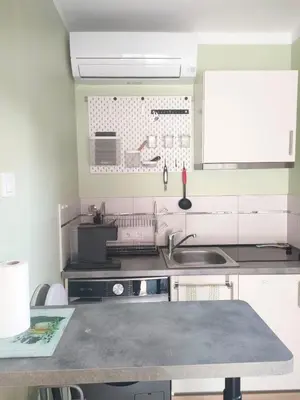 a kitchen with a sink and a counter top at Mayka in LʼIsle-sur-la-Sorgue