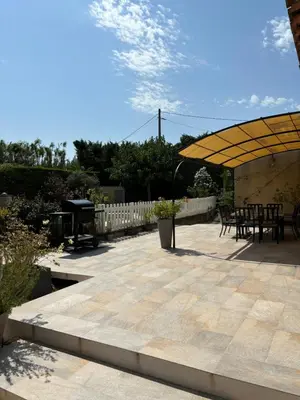 a patio with a yellow umbrella and a picnic table at Villa de caractères,piscine, vue sur le luberon,3 chambres in Cheval-Blanc