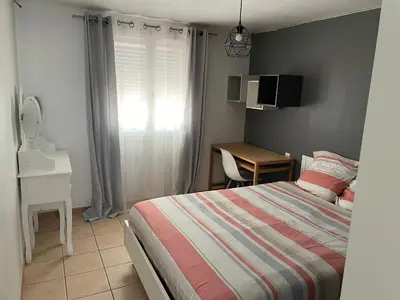 a bedroom with a bed and a desk and a window at Villa de caractères,piscine, vue sur le luberon,3 chambres in Cheval-Blanc